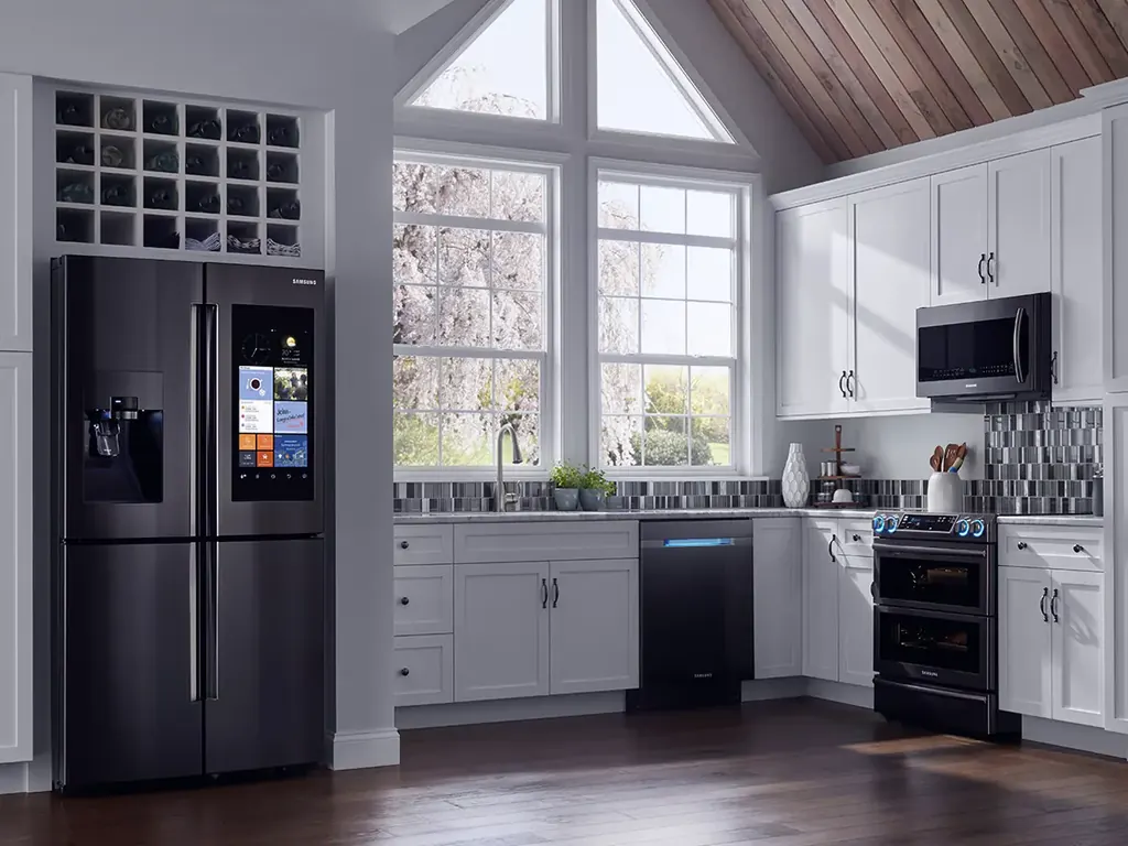 Orca technician servicing a refrigerator in a modern kitchen